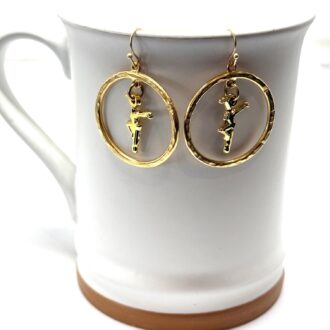 Gold Dancer Earrings on Mug